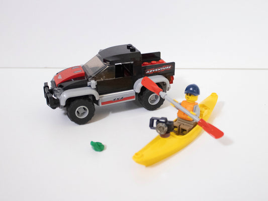 LEGO model of a truck and kayak with a person on a white background